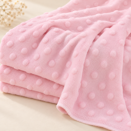 Blush pink Solid Dot Minky fabric draped to show its soft surface and raised dot texture