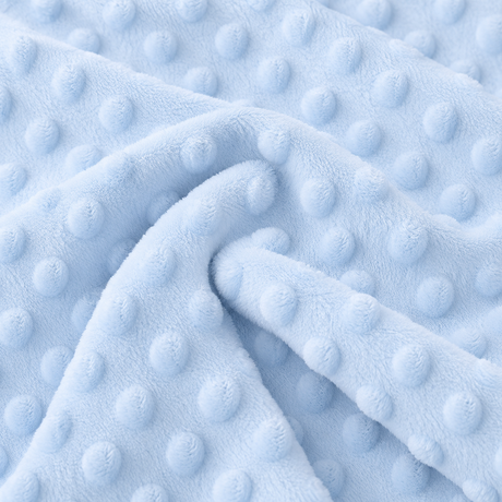 Close-up of pale blue Dot Minky fabric with evenly spaced raised dots and a soft textured surface