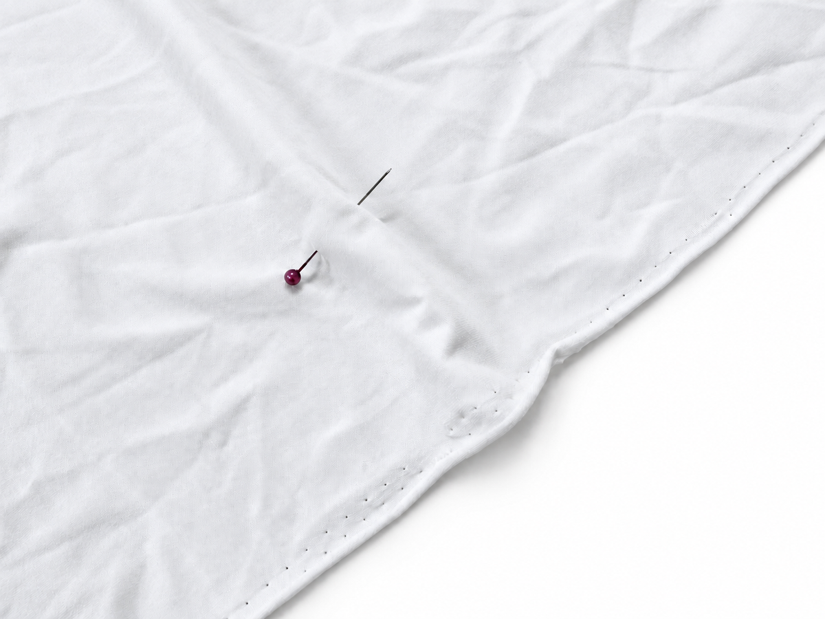 Close-up of a single white Light Double Brushed Poly fabric base with a smooth brushed surface